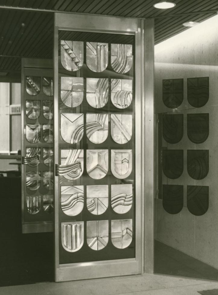 High Court of Australia, Public Hall entry doors for Courtroom 1, commissioned for the opening in 1980. The repetition and constant form of the shield imparts a sense of impartiality and universality as represented in the High Court. The shields represent the protection provided by the rule of law to the people.