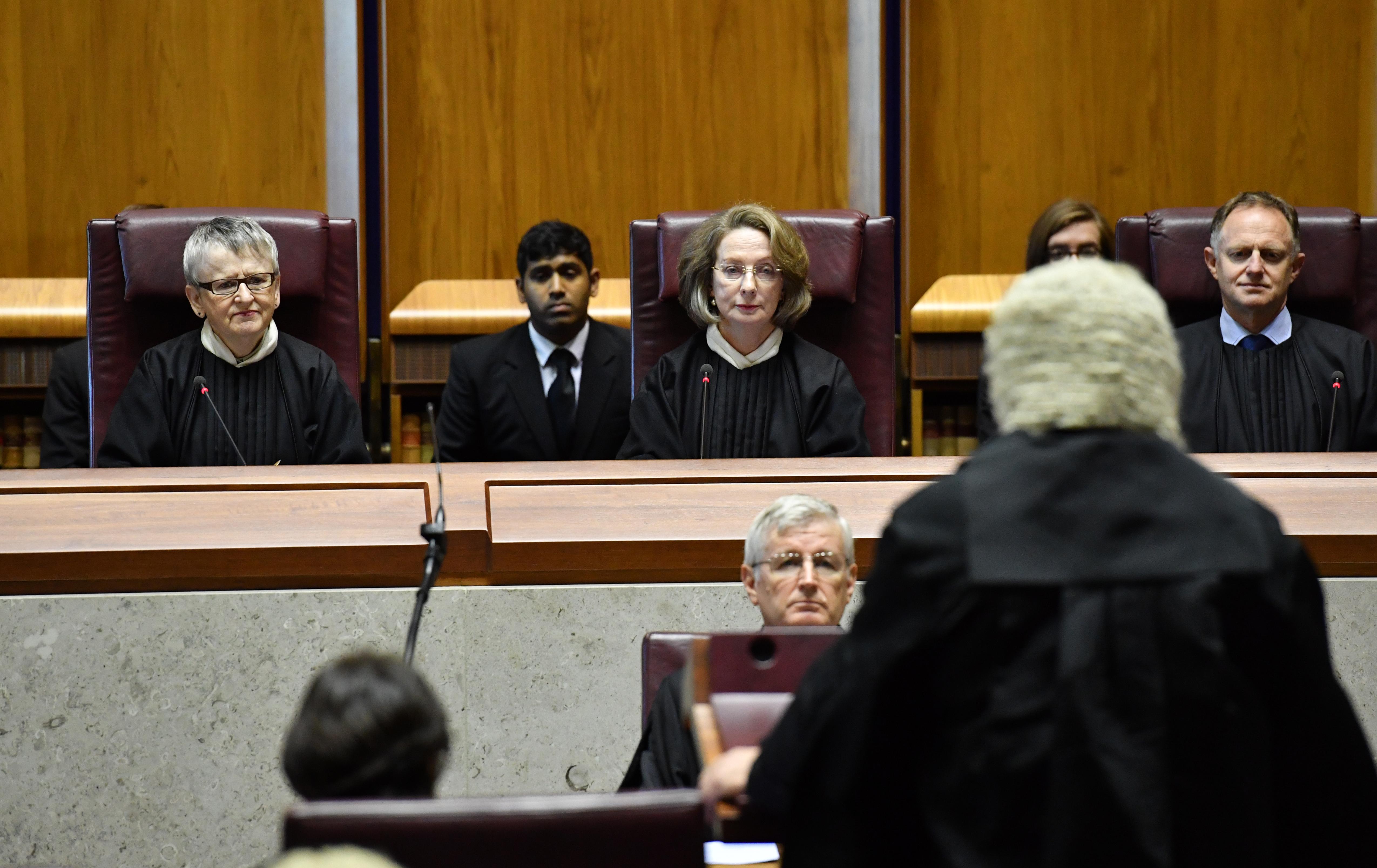 Attorney-General George Brandis makes a speech as Chief Justice Susan Kiefel (C) looks on after being sworn in as Chief Justice of the High Court in Canberra, 30&nbsp;January 2017.
